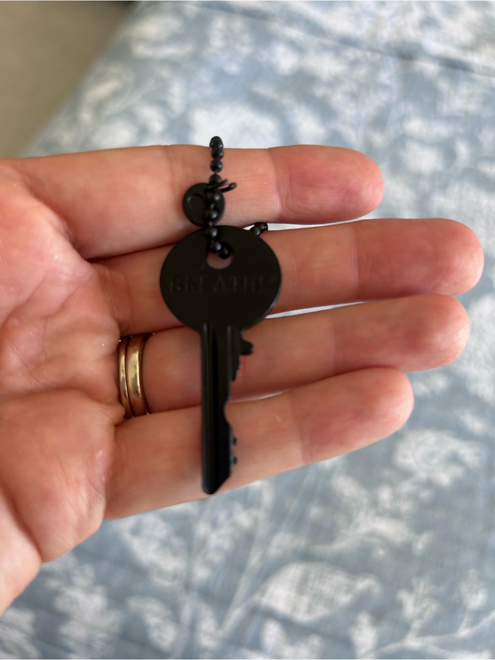 The Giving Keys Black 'Breathe' Matte Key Necklace and Gold Breath key
